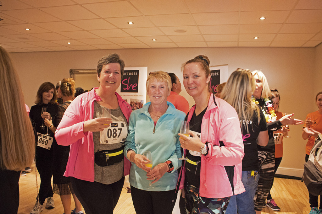 Three of the runners posing with their prosecco before they head for the start line. 