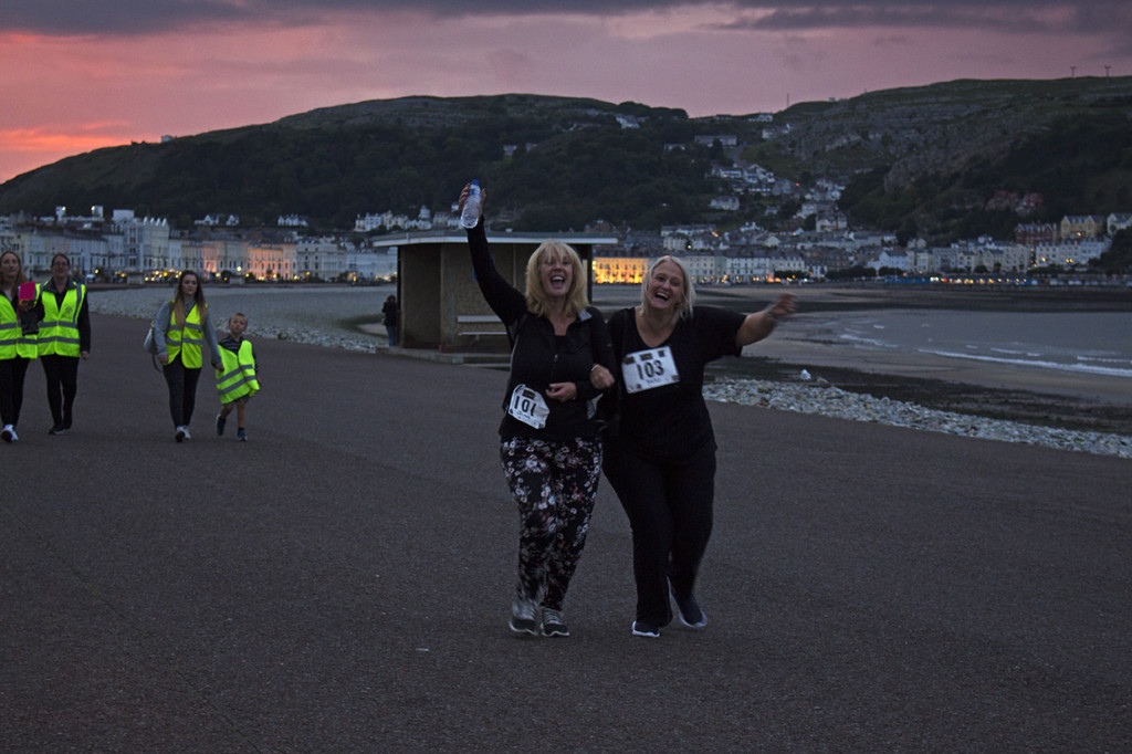 The last two ladies coming across the finish line to end the 1st Fizzy Friday 5k.