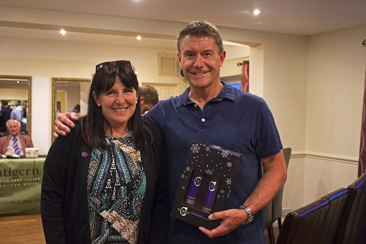 One of the attendees with his auction item he won.