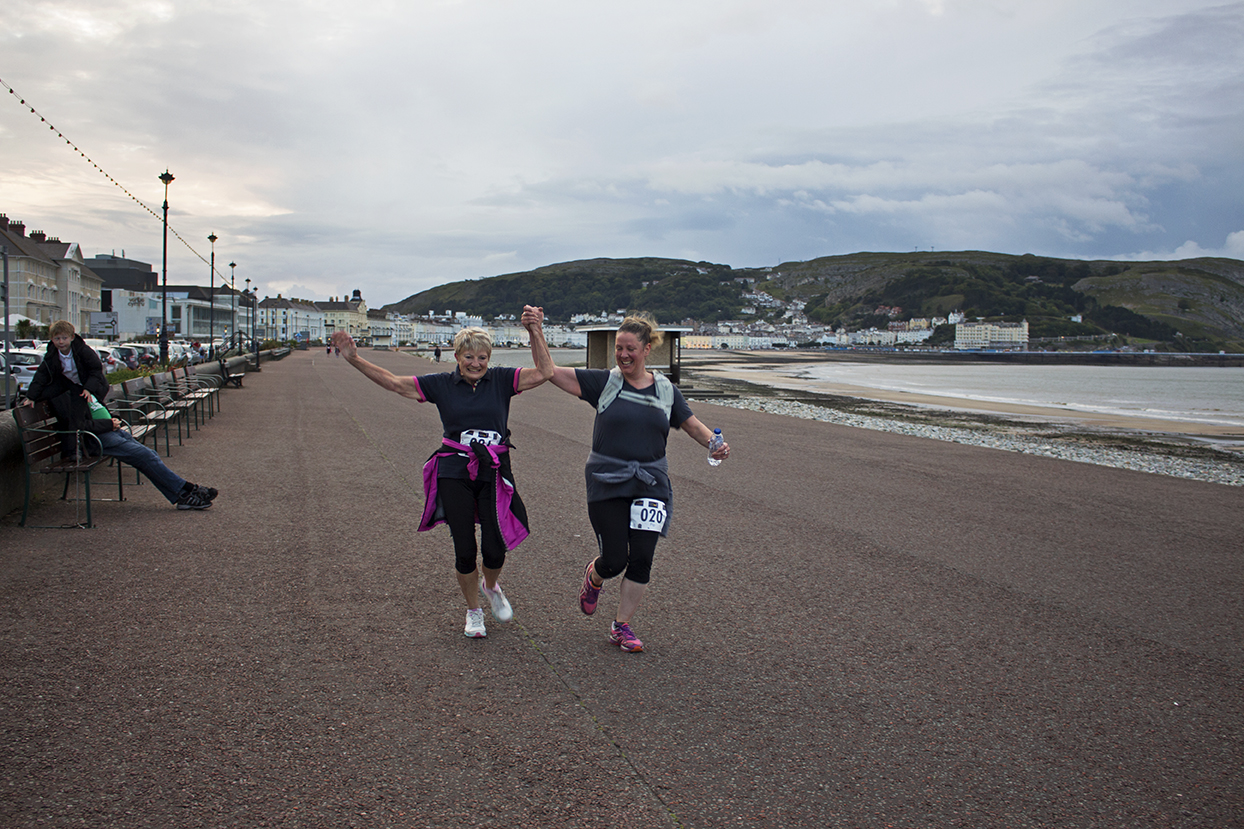 Some more runners crossing the finishing line.
